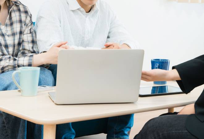 夫婦に説明する女性調査員。